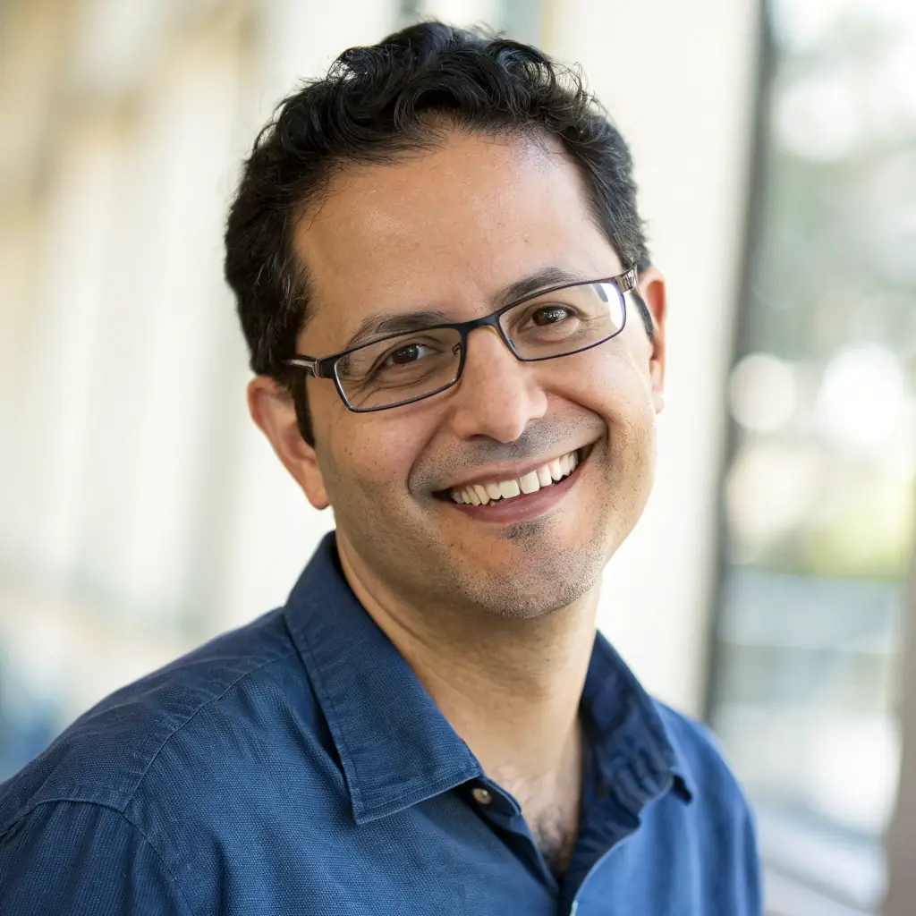 A professional headshot of DuoDuo28's Chief AI Scientist, a person with a friendly and intelligent expression, in a modern office setting.